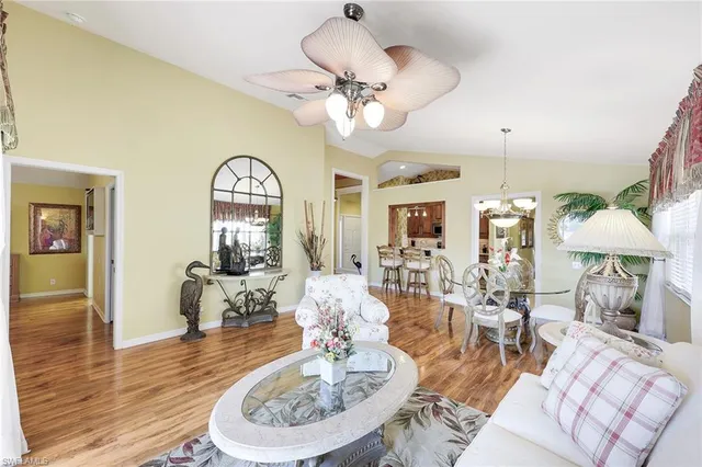 a view of a dining room with furniture a chandelier and wooden floor