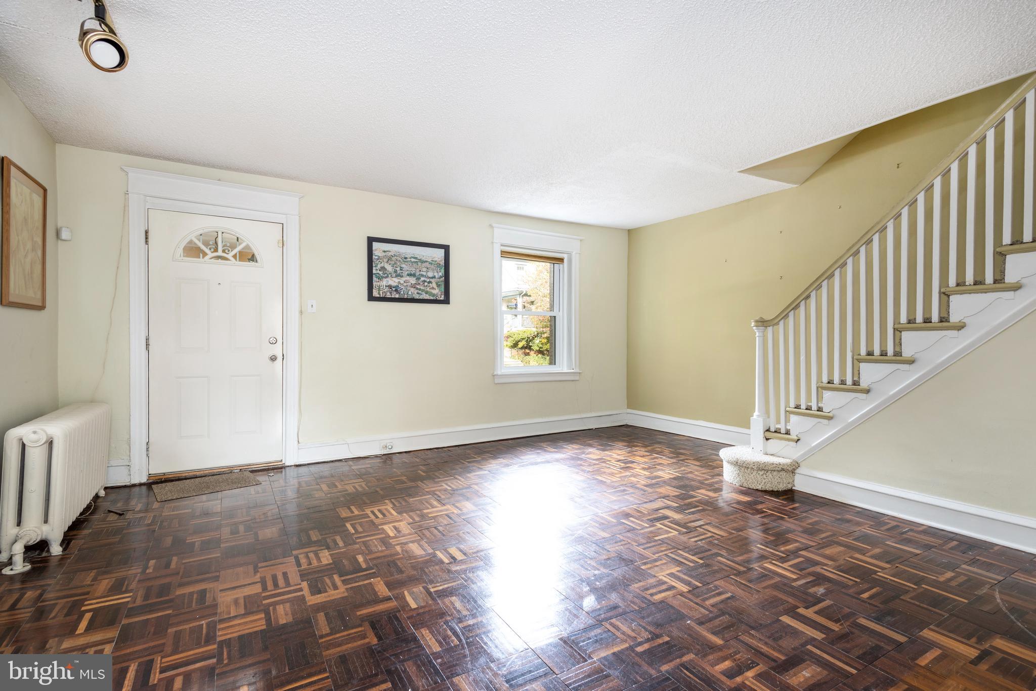 442 Wellesley Road Philadelphia, PA 19119 - Photo 6 of 18 a view of an empty room with window and wooden floor