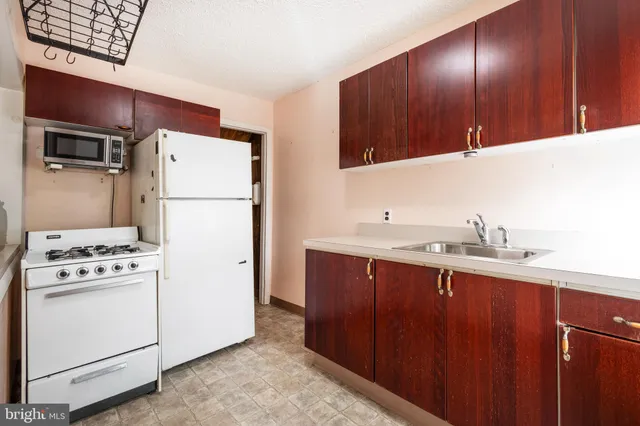 a kitchen with a white cabinets and white appliances