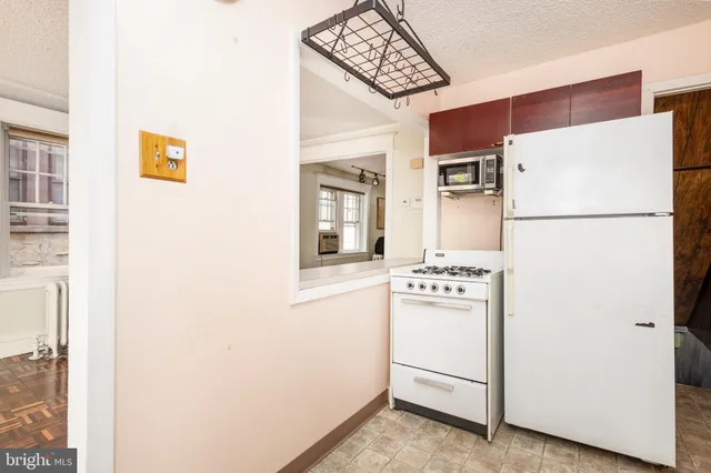 a white refrigerator freezer sitting inside of a kitchen