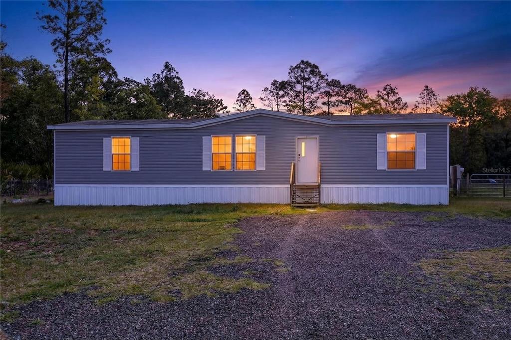2857 Hickory Street Bunnell, FL 32110 - Photo 1 of 22 a front view of a house with a yard