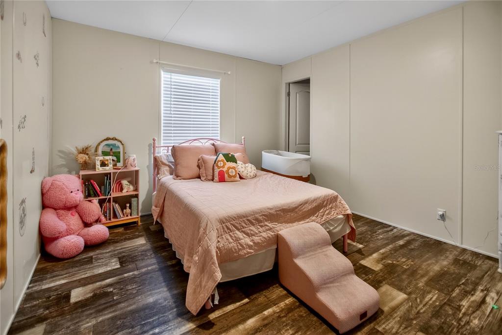2857 Hickory Street Bunnell, FL 32110 - Photo 11 of 22 a bedroom with a bed and wooden floor