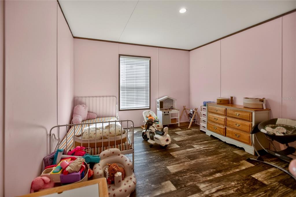 2857 Hickory Street Bunnell, FL 32110 - Photo 12 of 22 a bedroom with furniture and a couch