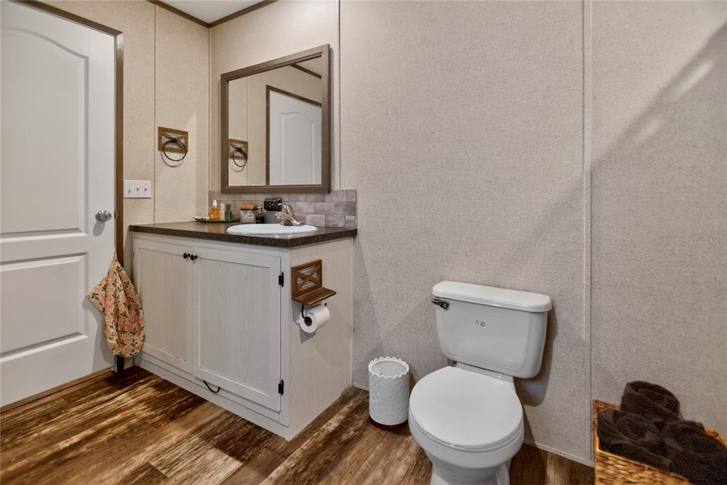 2857 Hickory Street Bunnell, FL 32110 - Photo 9 of 22 a bathroom with a toilet a sink and mirror