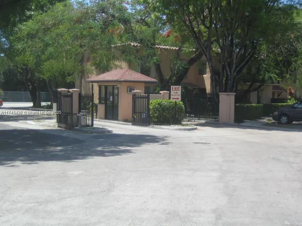a backyard of a house with barbeque oven and outdoor seating