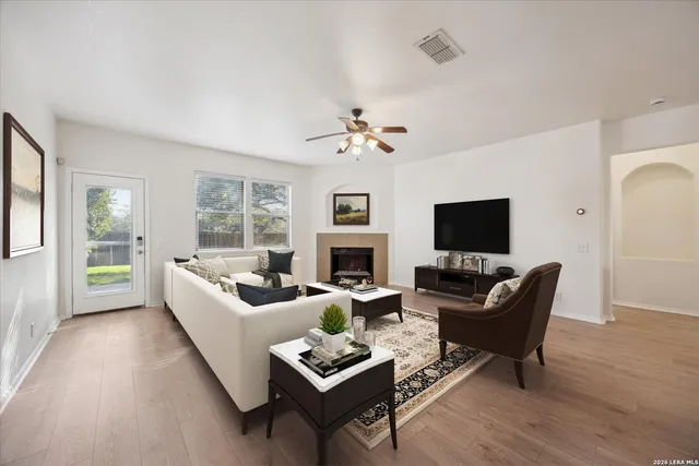a living room with furniture a fireplace and a flat screen tv