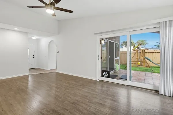 a view of an empty room with glass door
