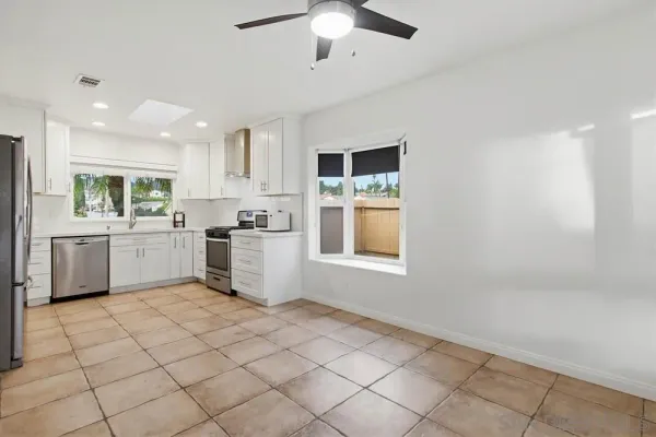 a kitchen with a sink cabinets and window