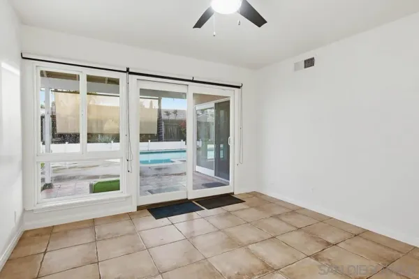 a kitchen with white cabinets stainless steel appliances and a window