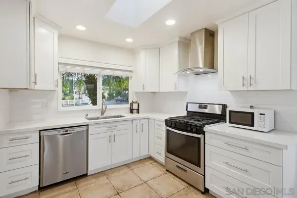 a kitchen with stainless steel appliances a refrigerator and a sink