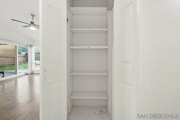 a view of hallway with wooden floor