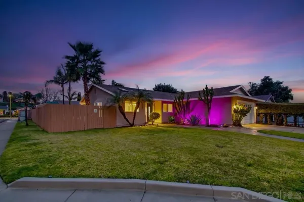 a view of an house with outdoor space and deck