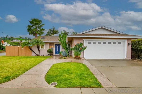 a front view of a house with a blue garage
