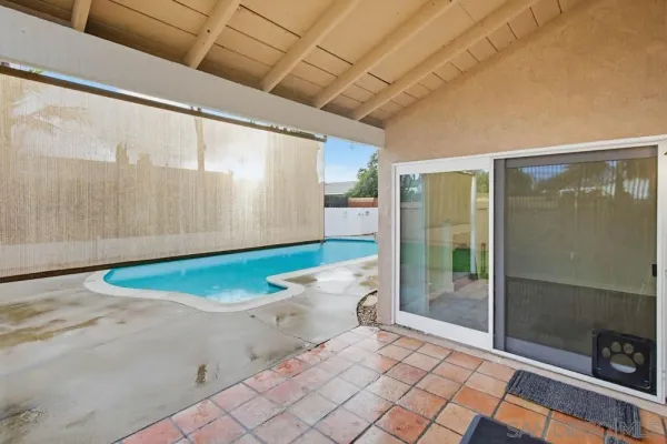 a view of a swimming pool with a patio
