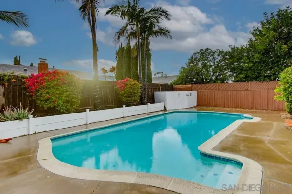 a view of a house with swimming pool and sitting area
