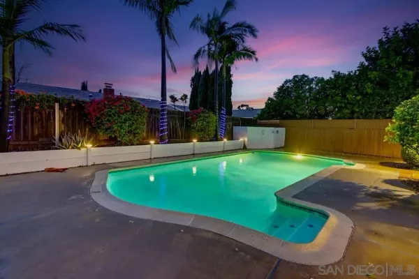 a swimming pool with outdoor seating and yard