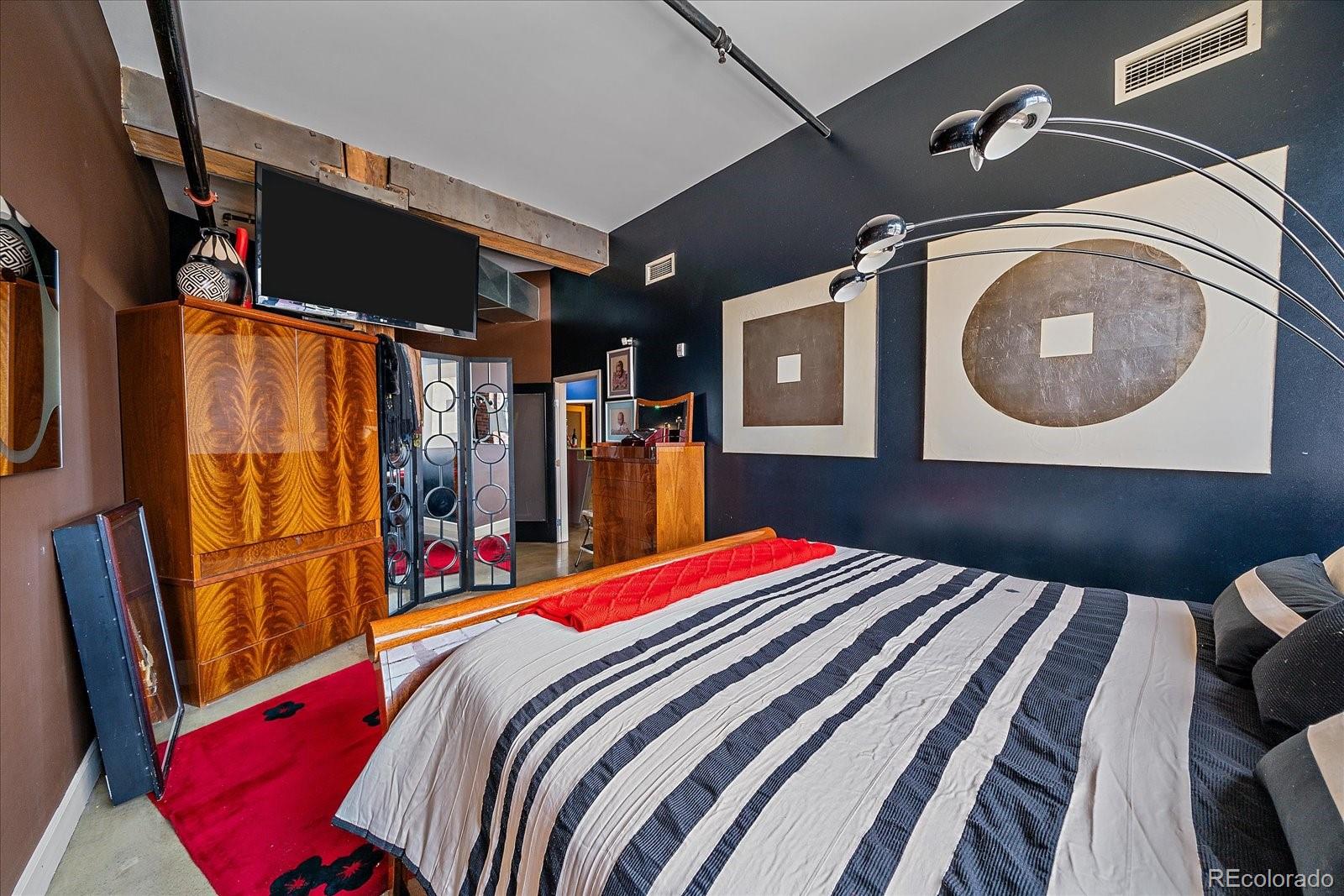 2500 Walnut Street, Unit 202 Denver, CO 80205 - Photo 18 of 31 a bed room with a bed and a mirror
