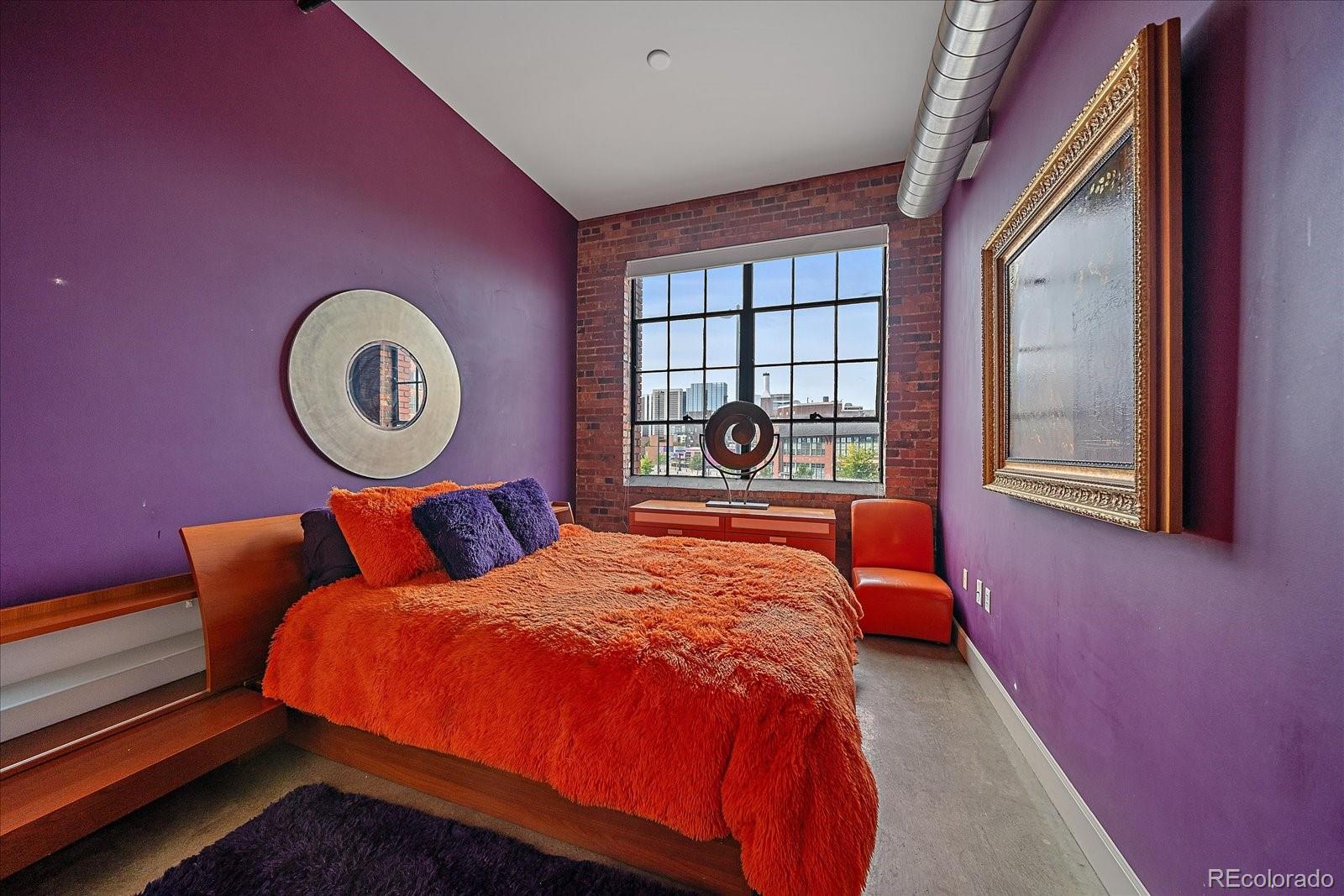 2500 Walnut Street, Unit 202 Denver, CO 80205 - Photo 22 of 31 a bed sitting in a bedroom next to a window