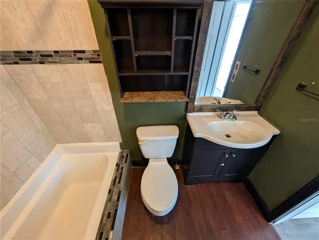 a bathroom with a sink toilet and tub