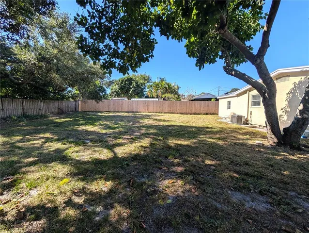 a view of a yard with a large tree