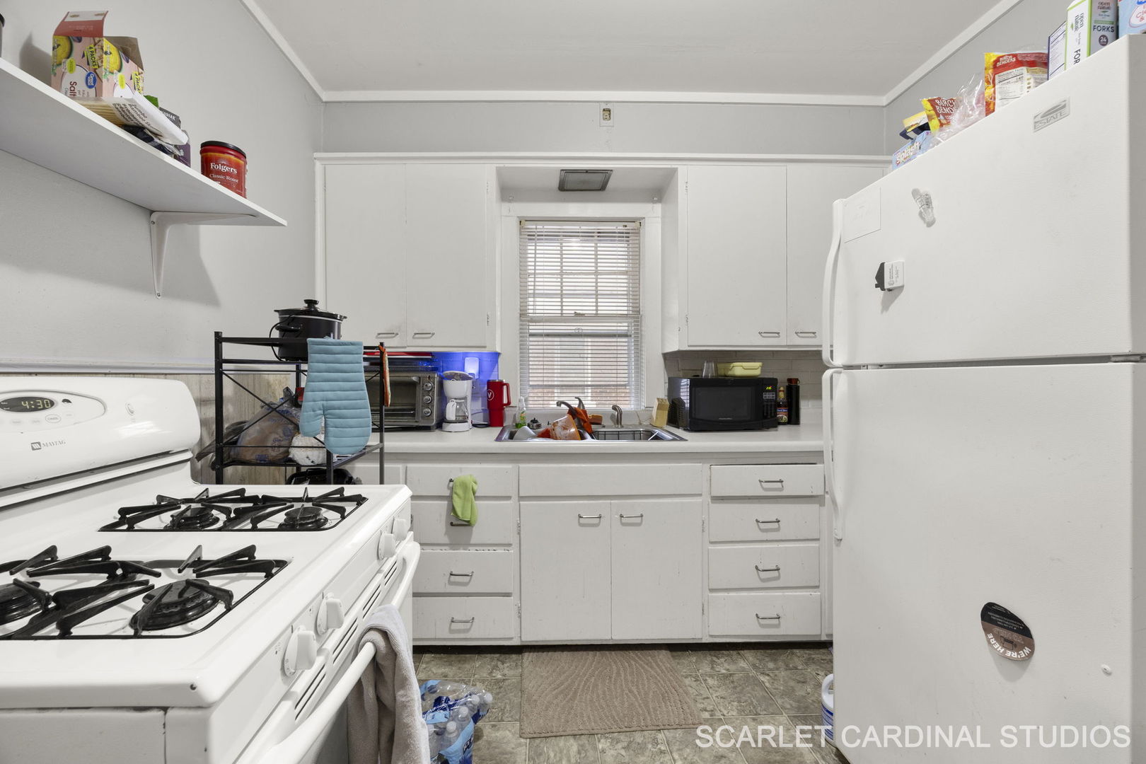 250 North Raynor Avenue Joliet, IL 60435 - Photo 14 of 17 a kitchen with a white stove and white cabinets