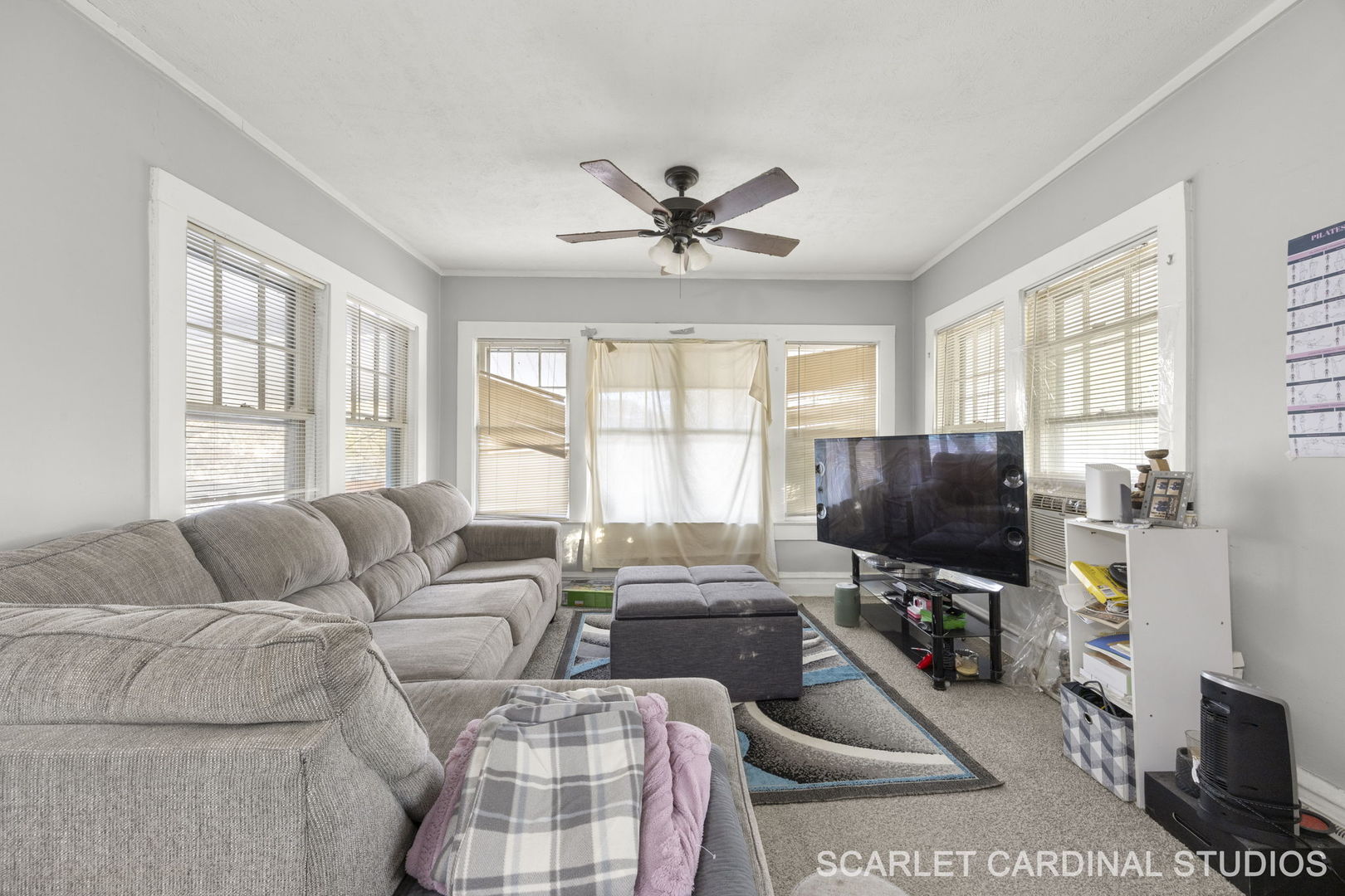 250 North Raynor Avenue Joliet, IL 60435 - Photo 16 of 17 a living room with furniture a flat screen tv and a window