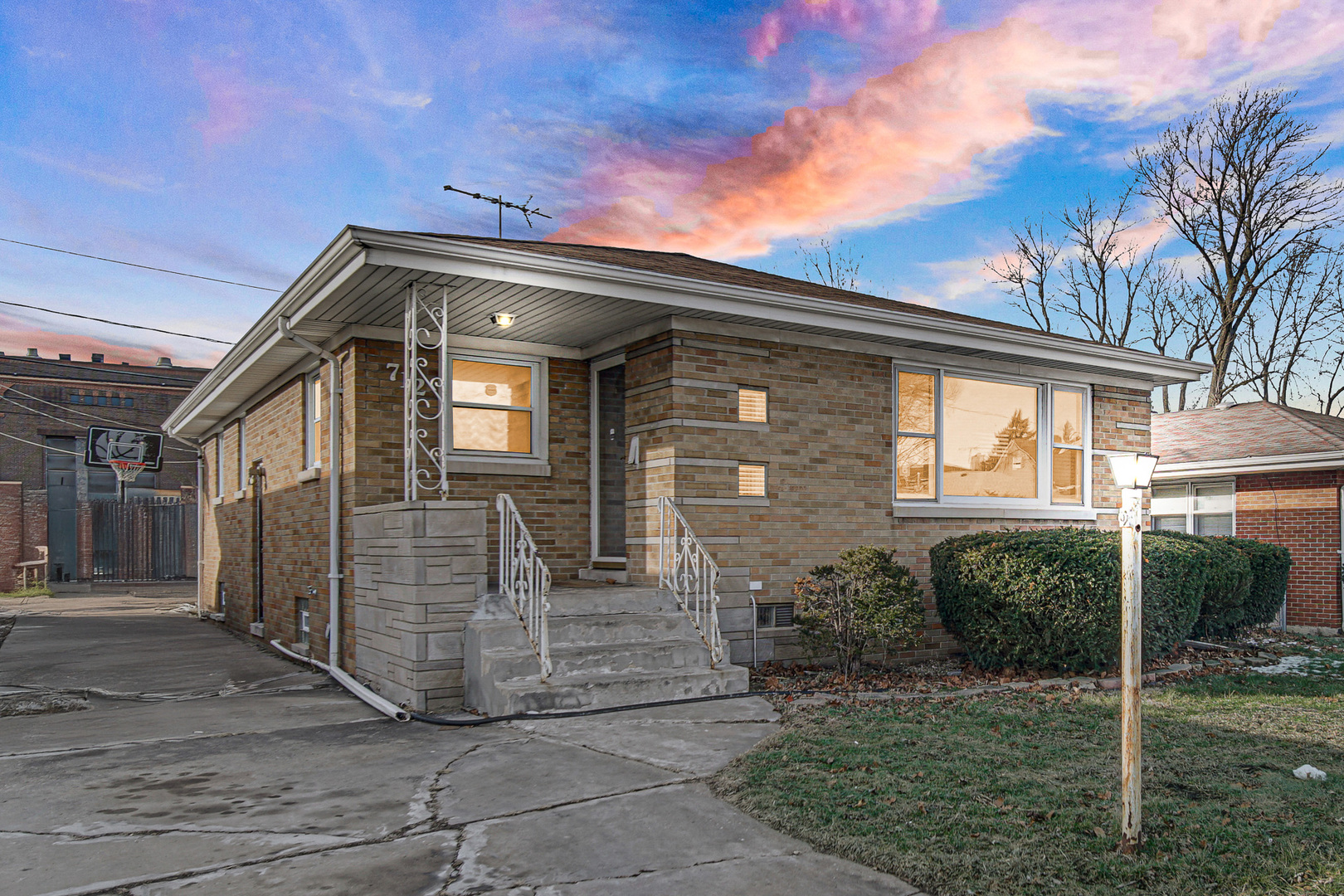 712 May Street Calumet City, IL 60409 - Photo 2 of 28 a front view of a house with a garden