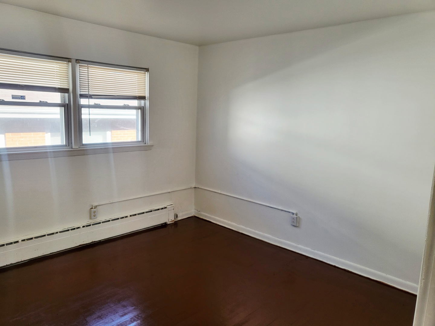 712 May Street Calumet City, IL 60409 - Photo 10 of 28 an empty room with wooden floor and windows