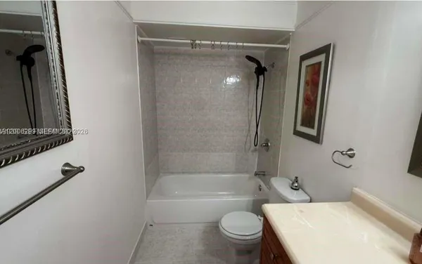 a bathroom with a toilet and a tub