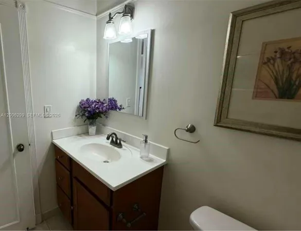 a bathroom with a sink toilet and vanity