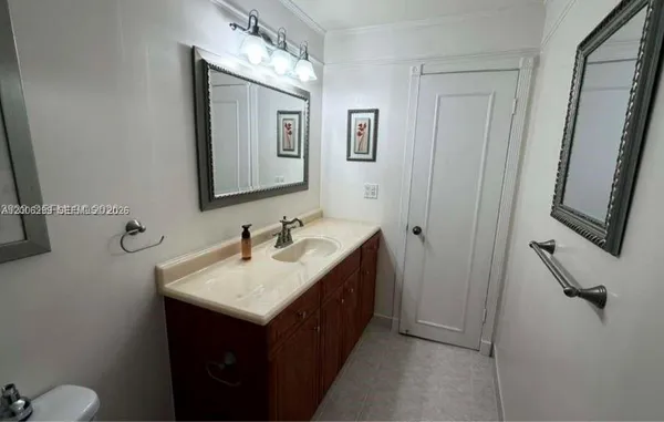 a bathroom with a sink vanity and mirror