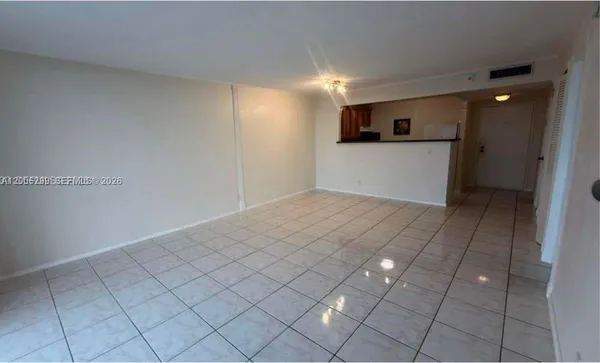 a view of a kitchen with a sink and a refrigerator