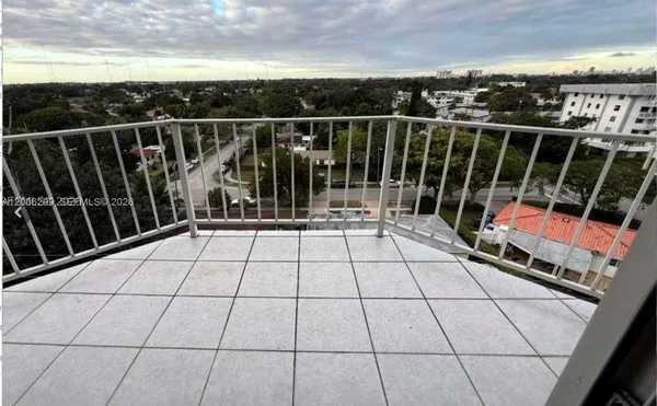 a view of balcony with wooden floor and fence