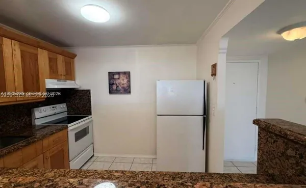 a kitchen with stainless steel appliances granite countertop a refrigerator a stove a sink and dishwasher