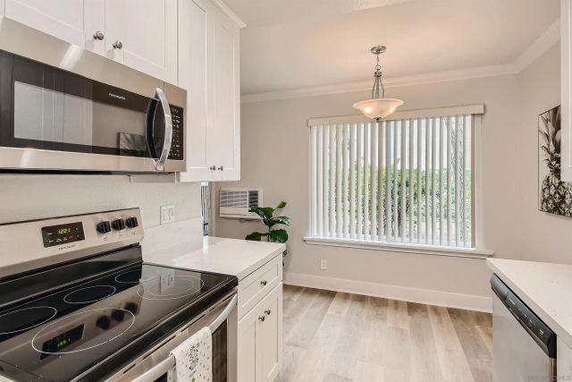 a kitchen with a stove a sink and a microwave