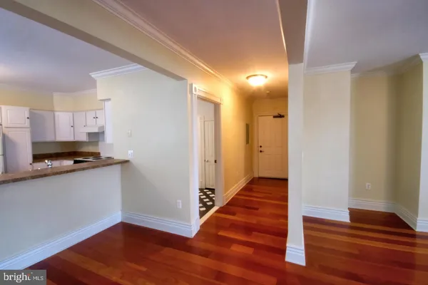 a view of a kitchen with wooden floor and a sink