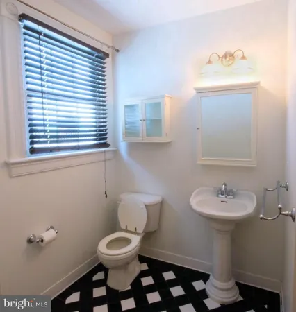a bathroom with a sink a mirror and a toilet