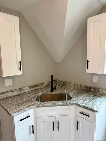 a kitchen with a sink and cabinets