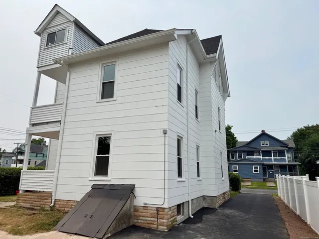 a view of a white house with large windows