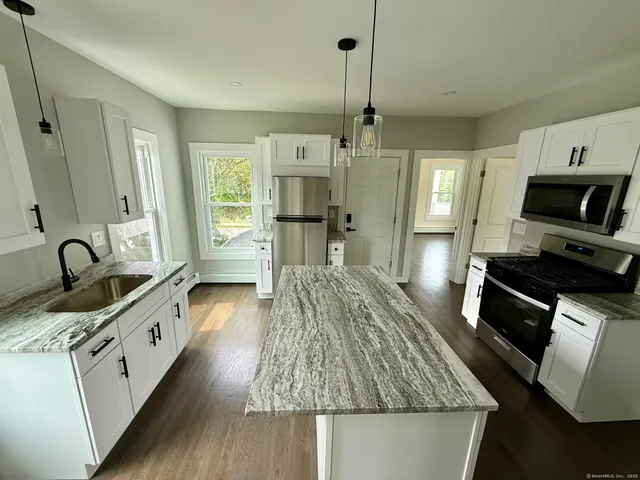 a kitchen with sink a stove and refrigerator