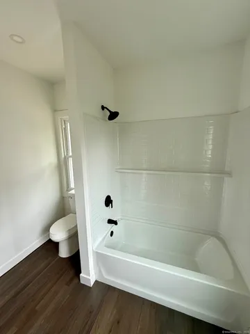 a bathroom with a bathtub and toilet