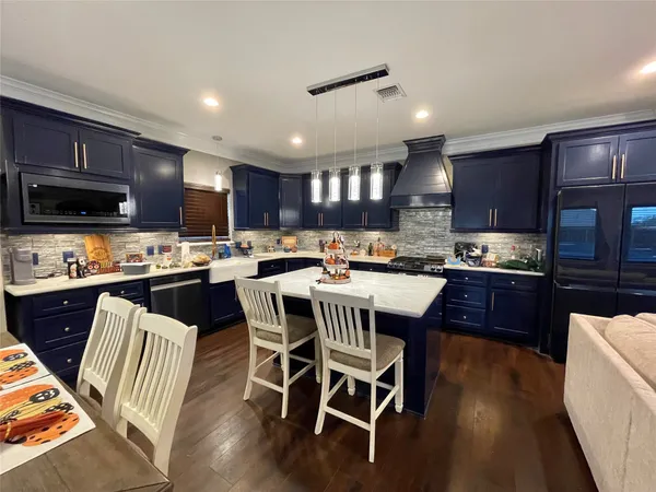 a dining room with furniture and wooden floor