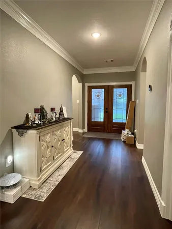 a view of a room with wooden floor