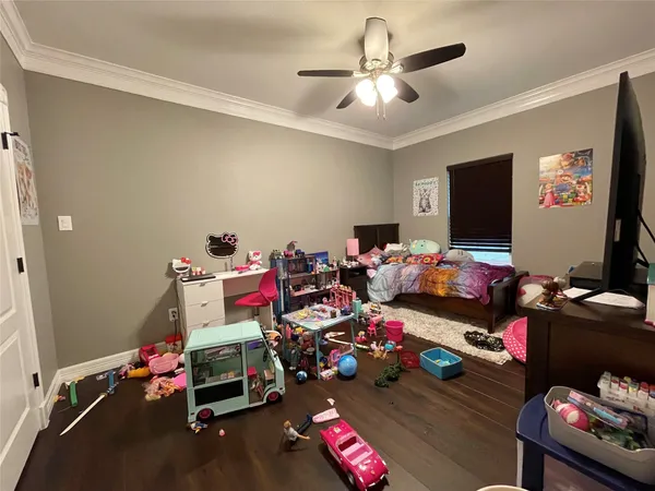 a play room with furniture and a flat screen tv