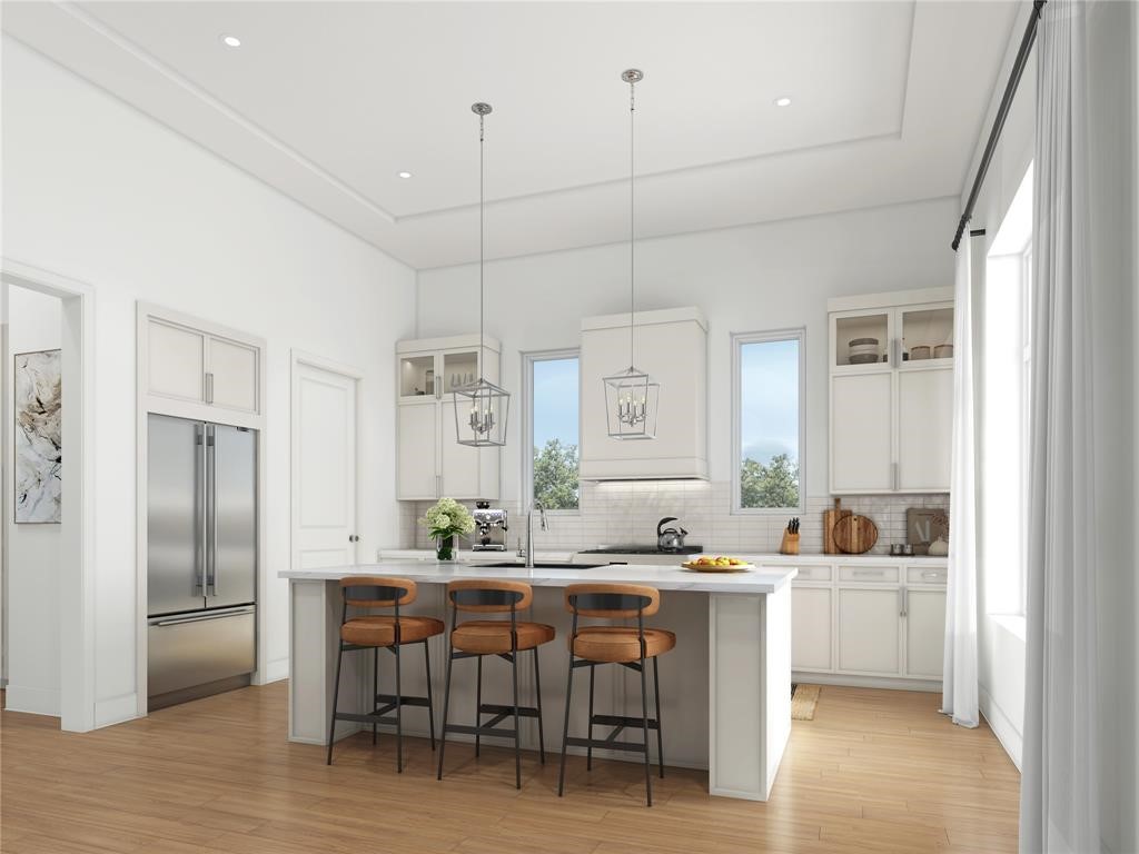 5327 Lambeth Riverside Drive Houston, TX 77091 - Photo 3 of 18 a kitchen with kitchen island a dining table chairs refrigerator and cabinets