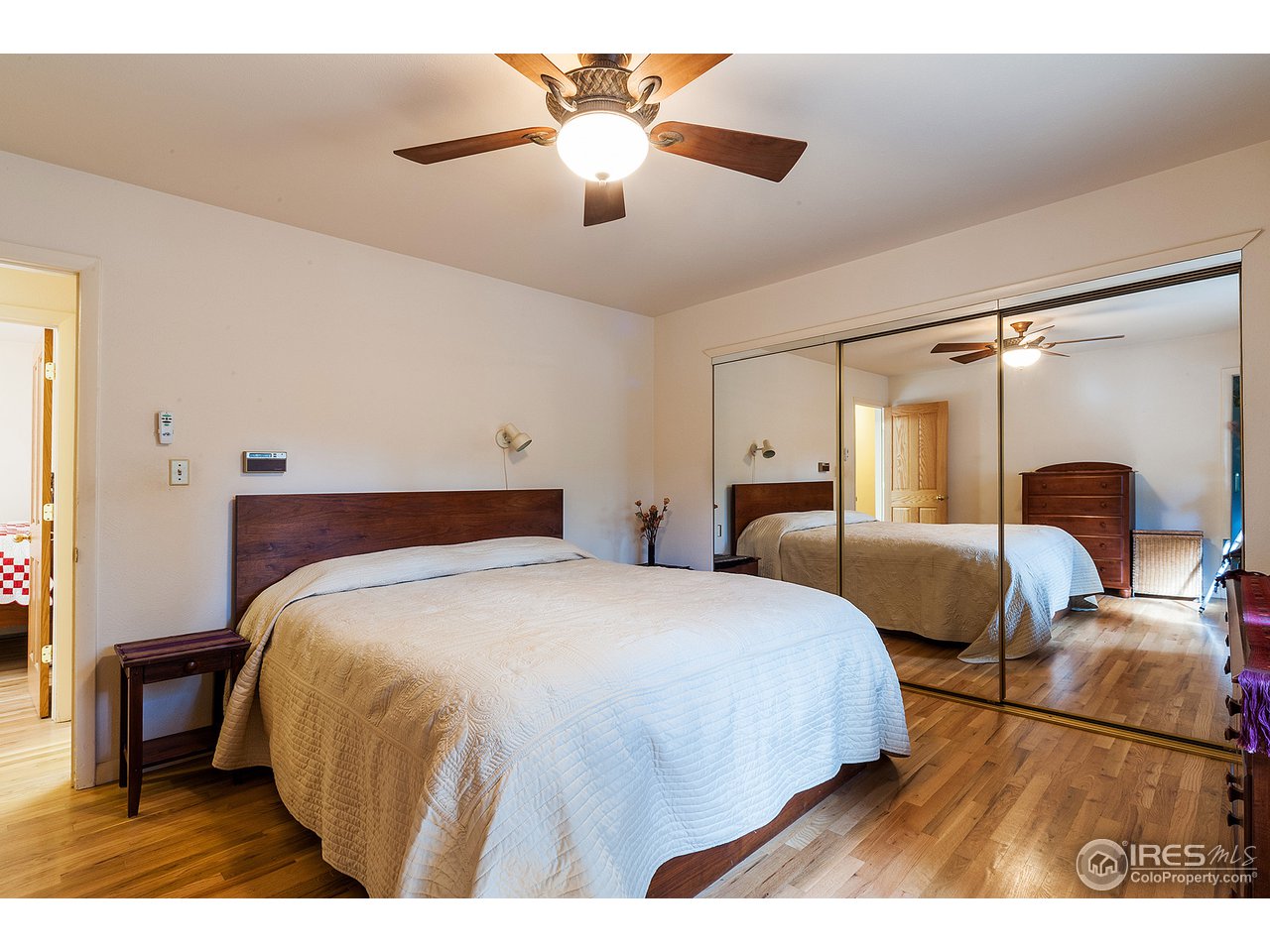 229 Kelly Road East Boulder, CO 80302 - Photo 13 of 25 a bedroom with a bed and a chandelier