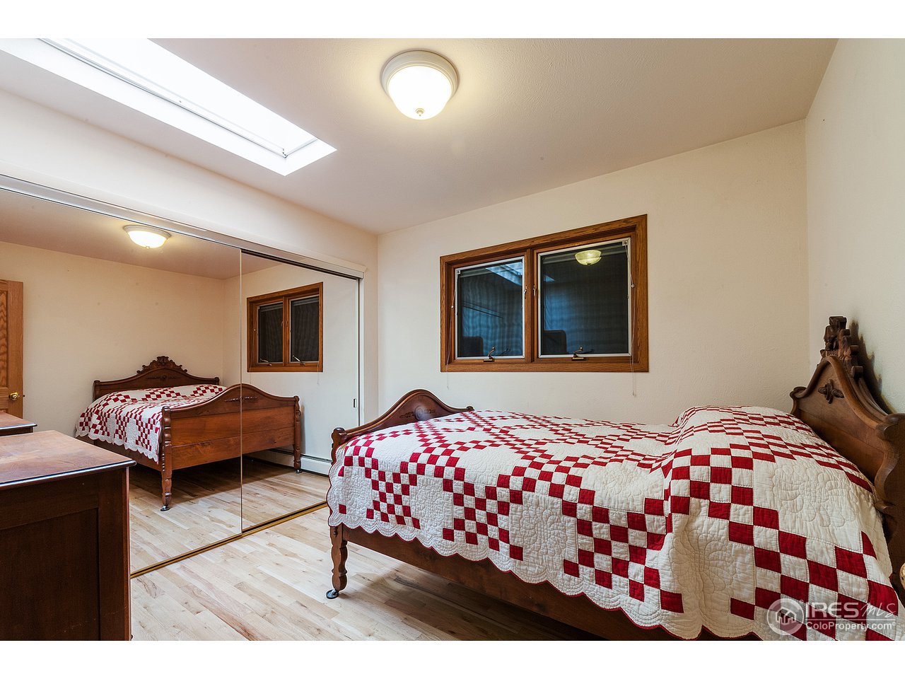 229 Kelly Road East Boulder, CO 80302 - Photo 15 of 25 a bedroom with a bed and wooden floor