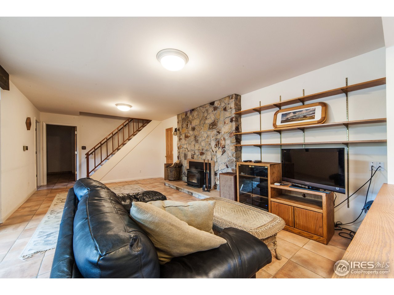 229 Kelly Road East Boulder, CO 80302 - Photo 19 of 25 a living room with furniture and a flat screen tv