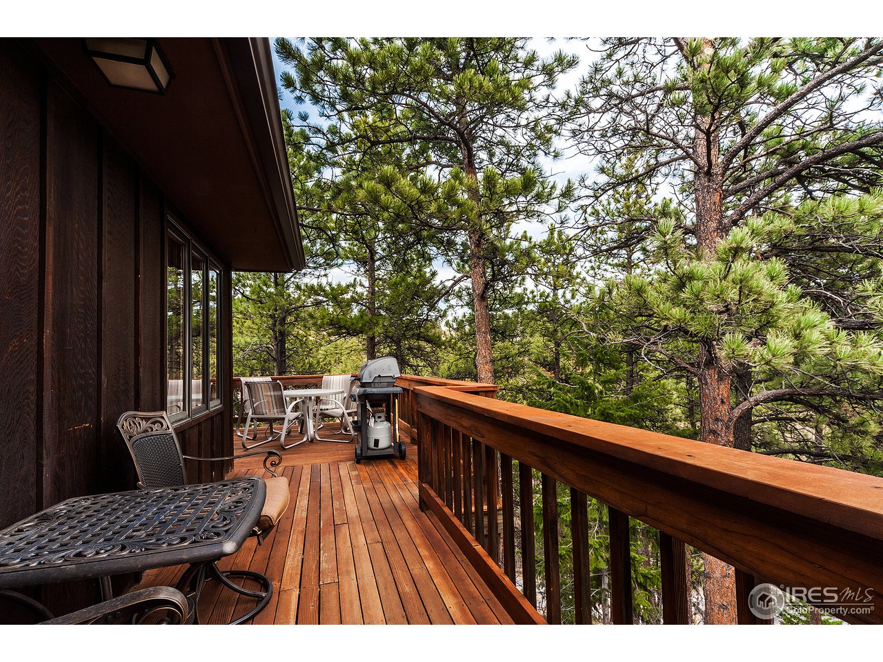 229 Kelly Road East Boulder, CO 80302 - Photo 4 of 25 a balcony with wooden floor and outdoor seating