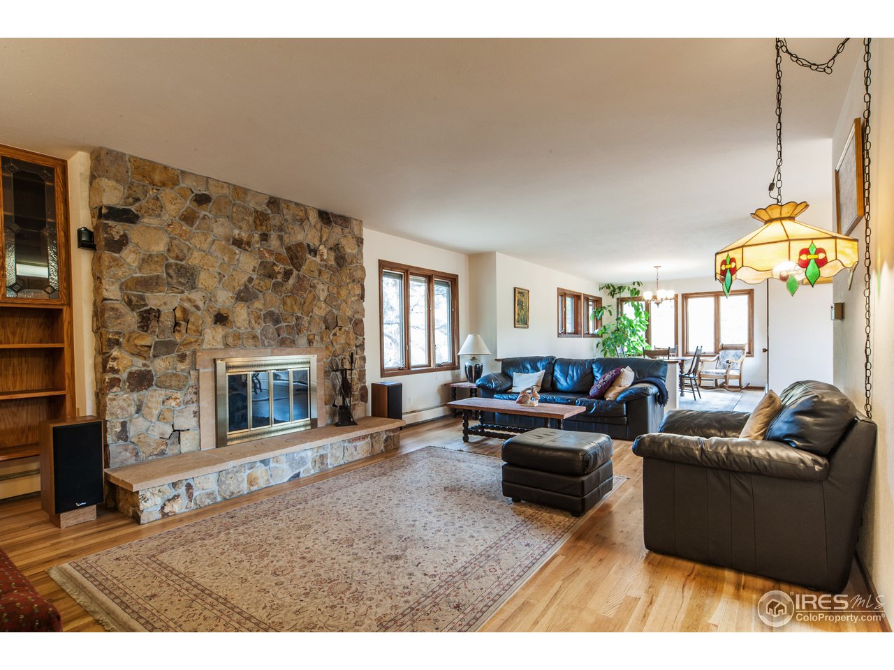 229 Kelly Road East Boulder, CO 80302 - Photo 8 of 25 a living room with furniture a fireplace and a flat screen tv